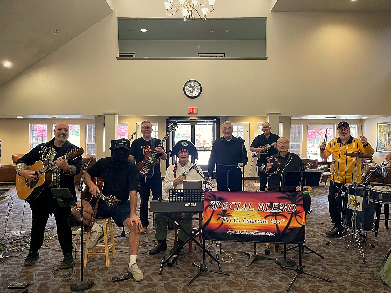 Special Blend seven-piece band smiling on stage at Independence Village