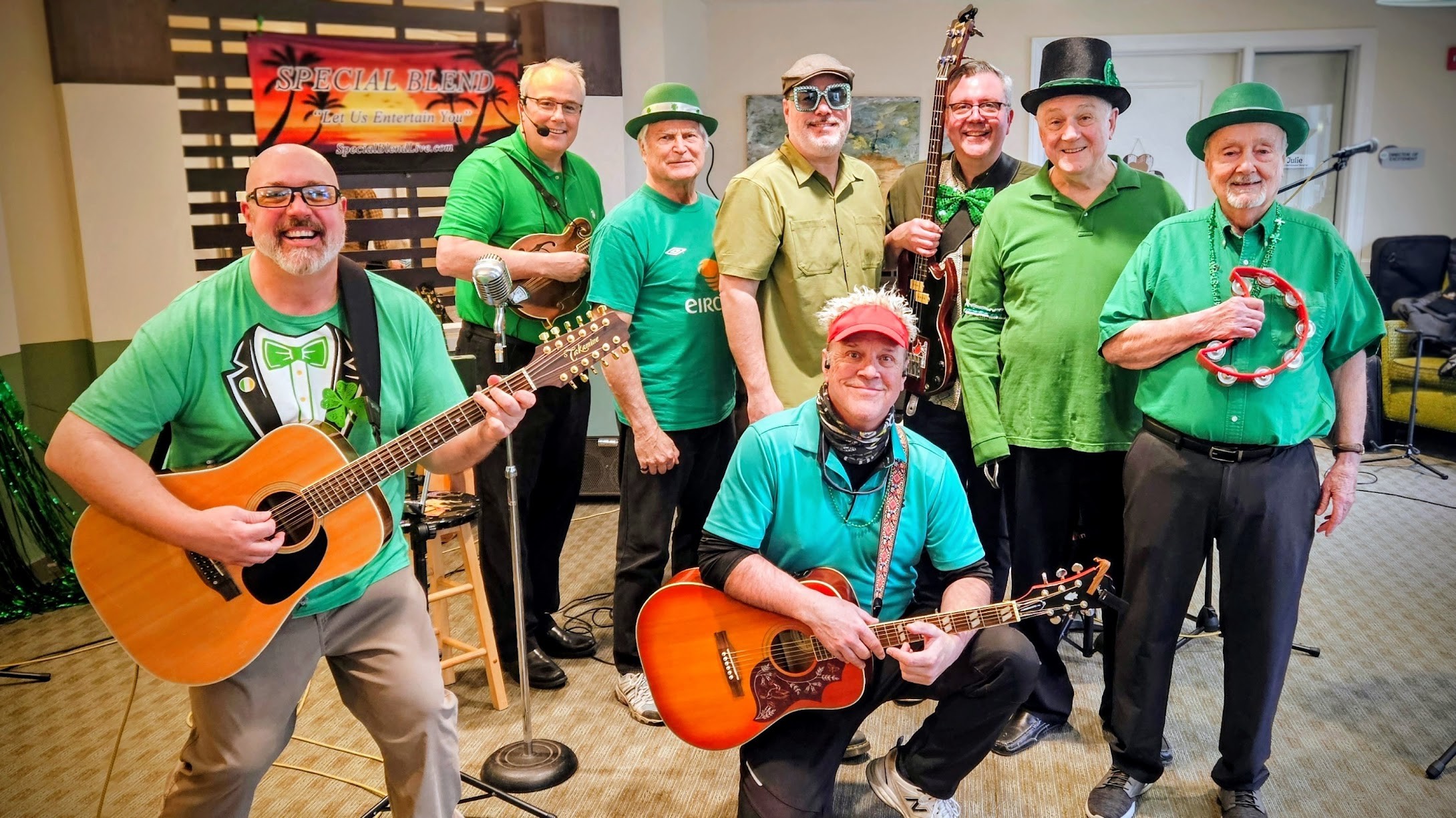 Special Blend full band dressed in St. Patrick's Day green in front of the Special Blend stage banner